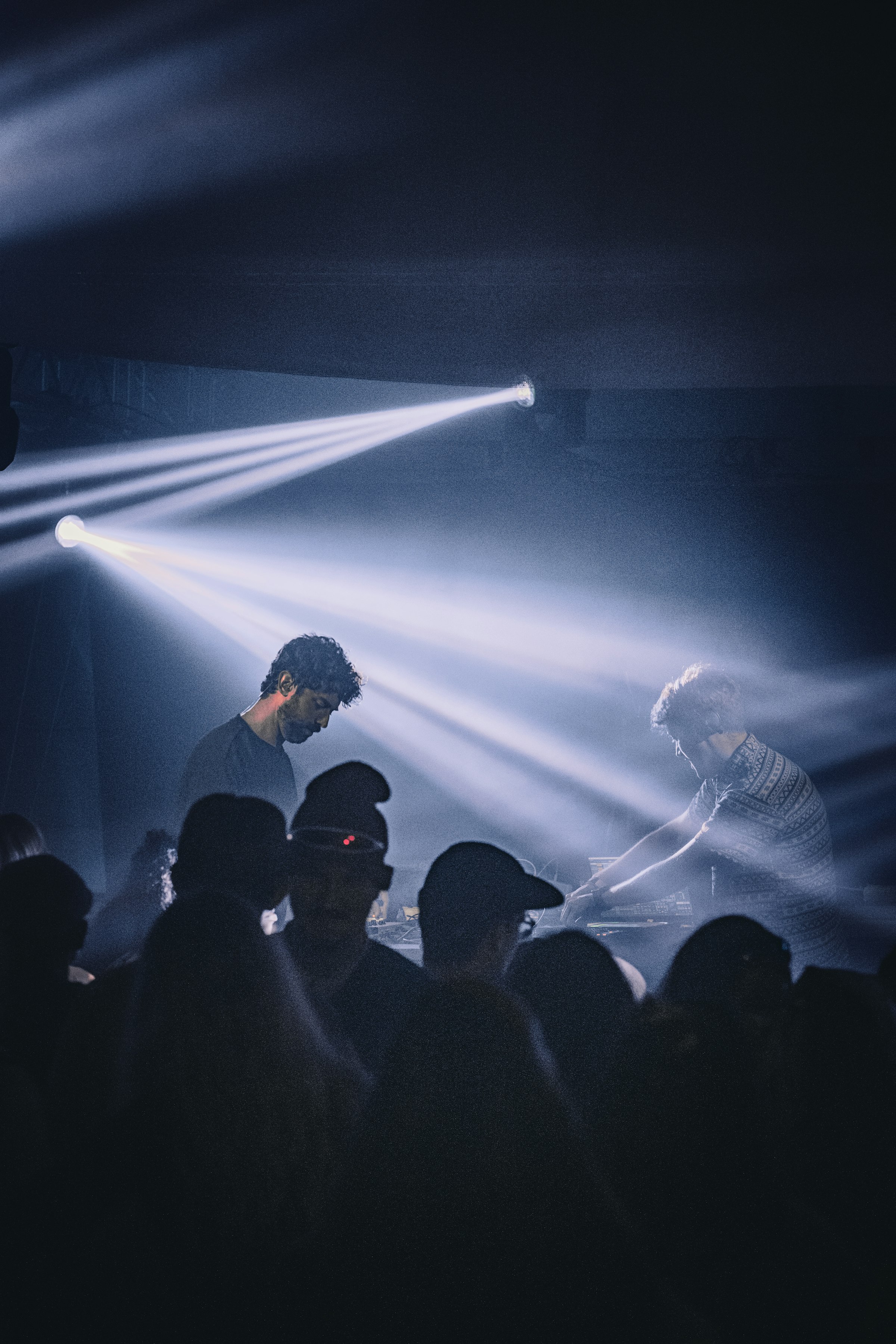 DJs performing in smoke and spotlights by Florian Schindler